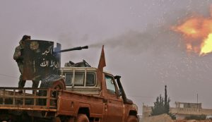 TOPSHOT - Syrian opposition fighters fire towards positions held by Islamic State (IS) group jihadists in al-Bab on the northeastern outskirts of the northern embattled city of Aleppo on December 13, 2016.  / AFP / Saleh ABO GHALOUN        (Photo credit should read SALEH ABO GHALOUN/AFP/Getty Images)