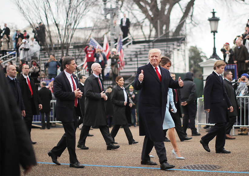 U.S. President Donald Trump gestures while walking with wife Melania and son Barron during the Inaugural Parade in Washington, January 20, 2017. Donald Trump was sworn in earlier as the 45th President of the United States. (Carlos Barria/Reuters)