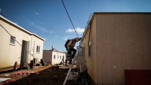 Construction workers work on clearing land for new caravans in the Jewish settlement of Ofra, in the West Bank, on January 29, 2017. (Yaniv Nadav/FLash90)
