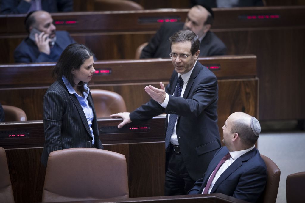 Jewish Home party leader Naftali Bennett (right), party colleague and Minister of Justice Ayelet Shaked and leader of the opposition Isaac Herzog seen in the Knesset just prior to the passage of the Regulation Law, which retroactively legalizes outposts built in the West Bank. (Yonatan Sindel/Flash90)