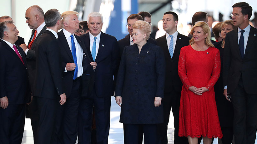 U.S. President Donald Trump adjusts his jacket after pushing past Montenegro Prime Minister Dusko Markovic the NATO Summit in Brussels, Belgium, May 25, 2017. (Kevin Coombs/Reuters)