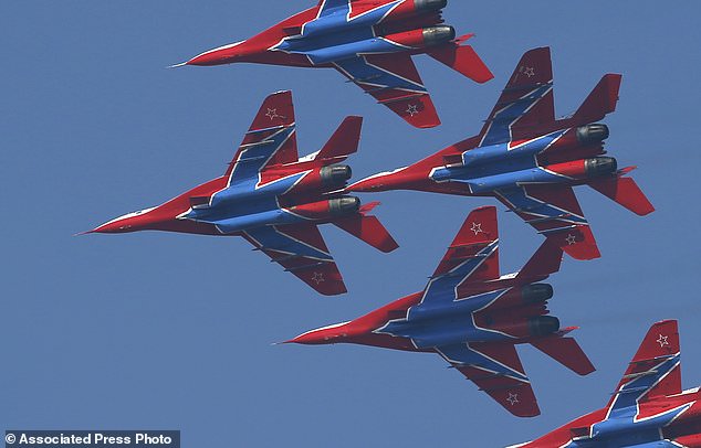MiG-29 jet fighters of Russian aerobatic team Strizhi (Swifts) perform during ceremony in Batajnica, military airport near Belgrade, Friday, Oct. 20, 2017. Russia has formally handed over six MiG-29 fighter jets to Serbia, part of an arms delivery that could worsen tensions in the war-weary Balkans. (AP Photo/Darko Vojinovic)