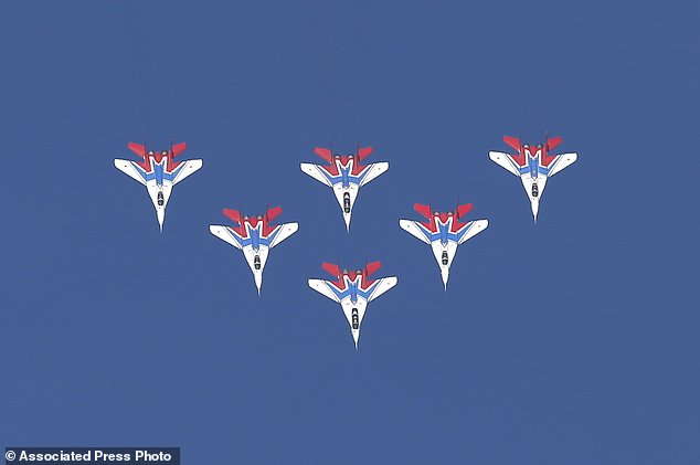 MiG-29 jet fighters of Russian aerobatic team Strizhi (Swifts) perform during ceremony in Batajnica, military airport near Belgrade, Friday, Oct. 20, 2017. Russia has formally handed over six MiG-29 fighter jets to Serbia, part of an arms delivery that could worsen tensions in the war-weary Balkans. (AP Photo/Darko Vojinovic)