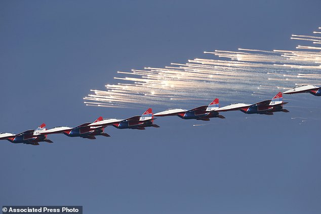 MiG-29 jet fighters of Russian aerobatic team Strizhi (Swifts) perform during a ceremony in Batajnica, military airport near Belgrade, Friday, Oct. 20, 2017. Russia has formally handed over six MiG-29 fighter jets to Serbia, part of an arms delivery that could worsen tensions in the war-weary Balkans. (AP Photo/Darko Vojinovic)