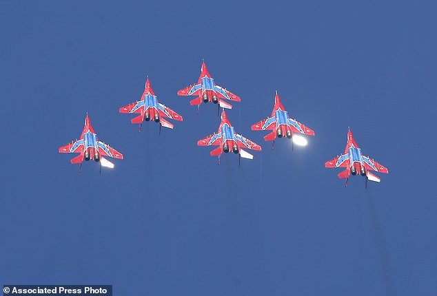 MiG-29 jet fighters of Russian aerobatic team Strizhi (Swifts) perform during ceremony in Batajnica, military airport near Belgrade, Friday, Oct. 20, 2017. Russia has formally handed over six MiG-29 fighter jets to Serbia, part of an arms delivery that could worsen tensions in the war-weary Balkans. (AP Photo/Darko Vojinovic)