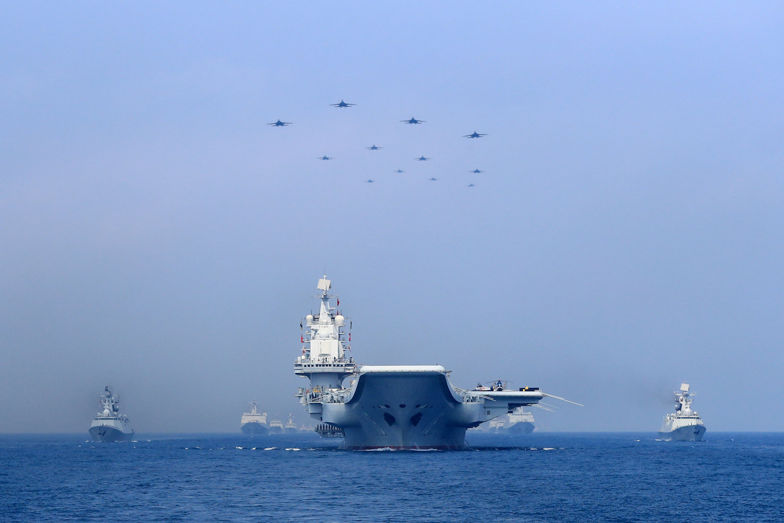Warships and fighter jets of Chinese People's Liberation Army (PLA) Navy take part in a military display in the South China Sea April 12, 2018. Photo: Reuters/Stringer 